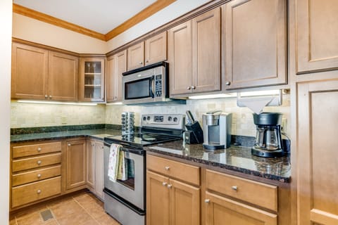 Full kitchen features a coffee maker, basic cooking essentials provided