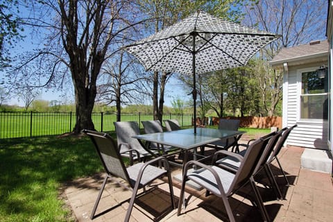 Enjoy outdoor dining surounded by tall majestic maple trees.