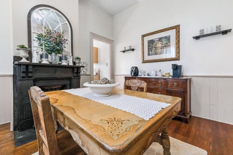 Enjoy family breakfasts at the vintage table by the charming mantel.