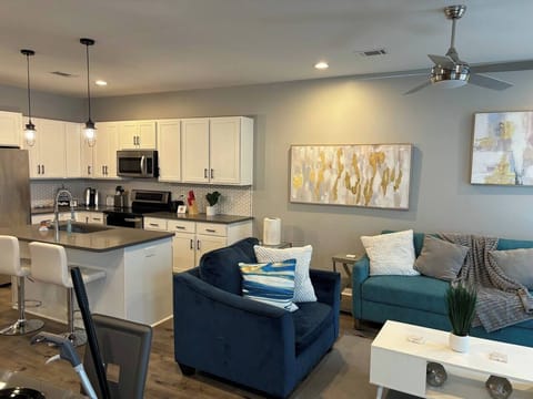 Living Room: Bright, modern space with stylish decor, sleek kitchen, and inviting seating. Perfect for relaxation!