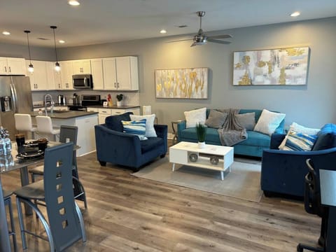 Living Room: Bright open space with modern decor, plush seating, and a stylish kitchen next door!