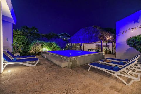 As dusk settles, our private pool glows a captivating blue, creating a truly magical atmosphere. Whether it's a refreshing late-night swim or simply enjoying the tranquil view from the nearby cabana, evenings here are unforgettable.