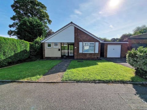 Welcome to this charming bungalow in Gatley with free private driveway parking right at the front door