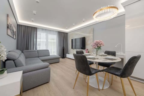 A cozy living room with a corner sofa and TV, perfect for relaxing after a day of exploring.