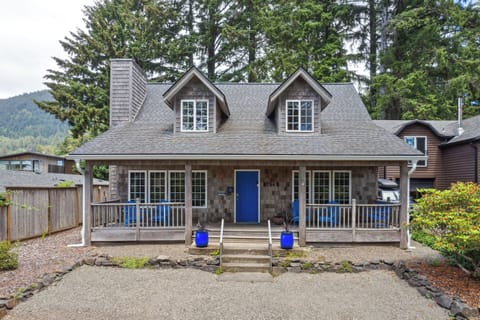 Street view with front covered porch with Adirondack chairs for relaxing in.