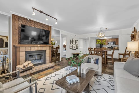 Living Room: 55” TV, wood burning fireplace, access to patio