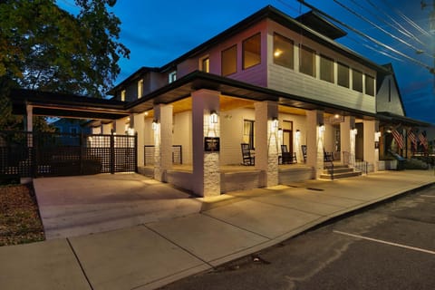 Welcoming façade with porch rockers for evening relaxation under soft lighting!

