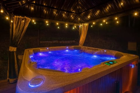 8 person hot tub with beautiful lightings, pergola and curtains