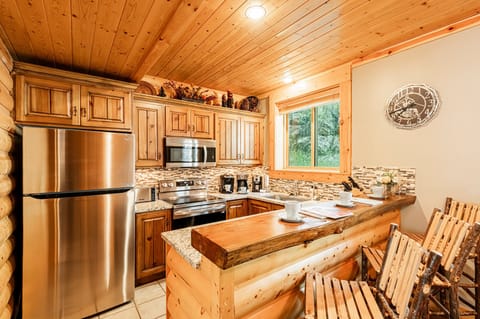 Fully equipped kitchen and bar seating for three