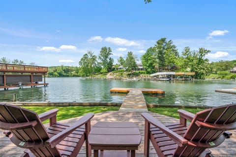 Relax in the adirondack chairs by the water