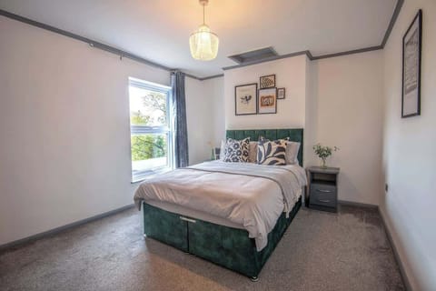 "Cozy comfort awaits — a first bedroom featuring a snug double bed for restful nights and relaxed mornings."