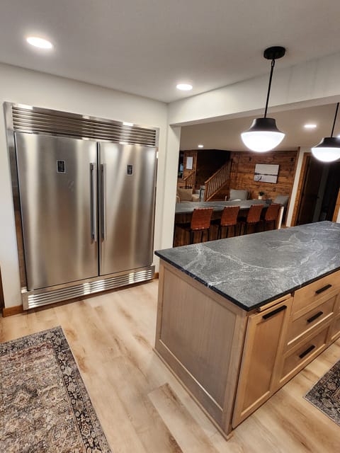 Full fridge and freezer. Islands are leathered granite.