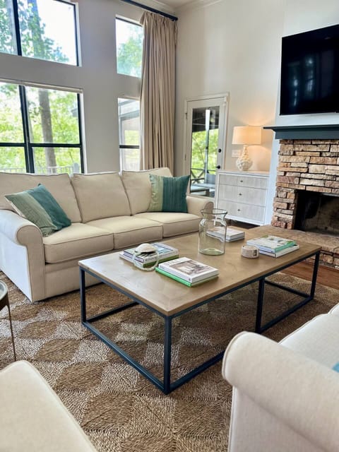 Relax in this spacious  living room with beautiful  lake views
