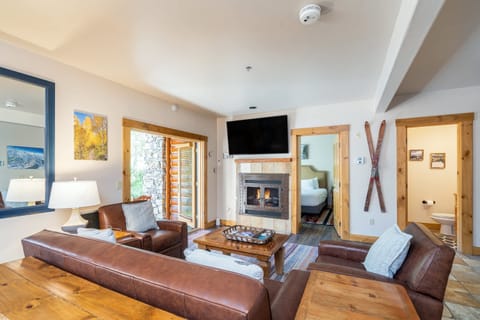Living Room: Couch w/pull out bed, 2 lounge chairs, gas fireplace, 50” TV, access to patio
