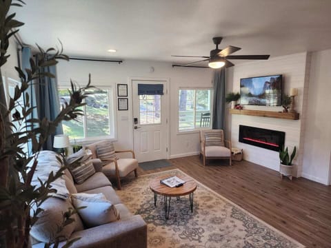 The welcoming living room features an electric fireplace and comfortable seating. Extra throw blankets are available, and the TV includes Netflix for your entertainment.
