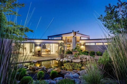 Front view of house from behind the pond and native garden.
