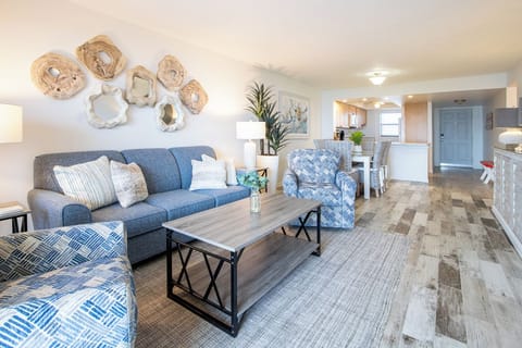 The bright and inviting living area offers plush seating warm decor and natural light