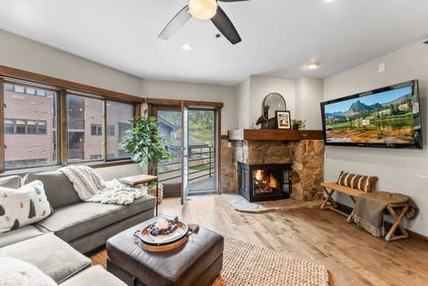 Living room: Couch w/queen pull-out bed, gas fireplace, 65” TV, dining table w/4 chairs
