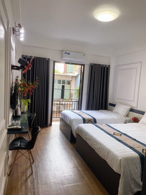 Deluxe Triple Room, City View | Desk, laptop workspace, free WiFi