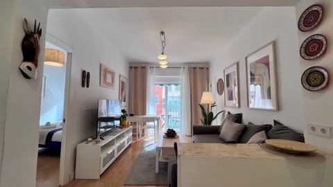 Bright modern lounge with dining area, natural light, and balcony access