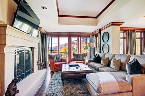 Inviting living room with a cozy fireplace and large windows.