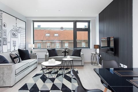 Integrated living, bedroom, and kitchen spaces in an open layout.
