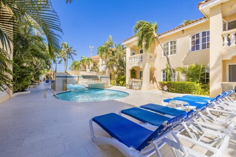 Unwind in style by the pool, surrounded by comfortable sun loungers and a spacious outdoor seating area, perfect for soaking up the sun and enjoying quality time with loved ones