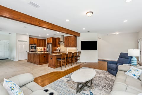 The living room features a large smart TV with streaming options