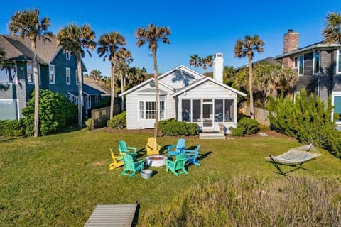 Front exterior of Retro Beachfront Bliss surrounded by palms