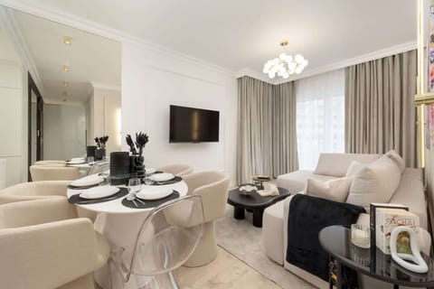 Stylish living room with a corner sofa, Smart TV and kitchenette.
