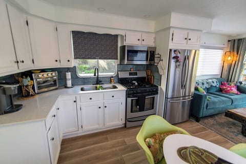 full kitchen minus a dishwasher.  Four gas burner stove, side by side full fridge w/freezer. new quartz counters.  Air fryer, microwave, Kuleg coffee maker, blender, cooking and dining and flatware service
