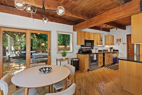 Dining area and kitchen, with sliders to outdoor dining and hot tub.