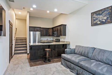 - Lower level kitchenette with granite counters  
- Stainless steel appliances and dark cabinetry  
- Comfortable sofa seating perfect for relaxing