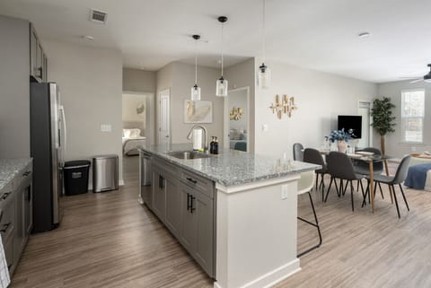 Welcome to our open kitchen! Fully equipped with sleek stainless steel appliances and ample counter space, it`s perfect for cooking and quick meals.