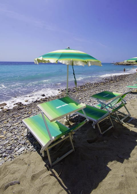 Private beach, black sand, sun loungers, beach umbrellas