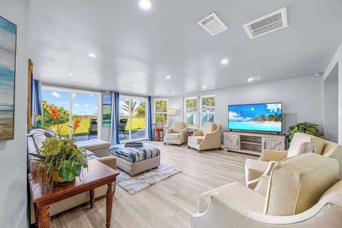 Spacious living room with large windows offering garden views and natural light