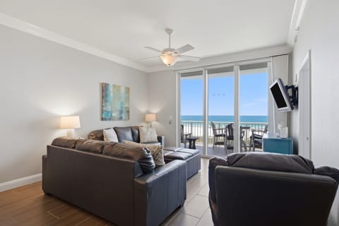 Step into your beachfront haven, where sleek leather seating and warm wood-tone floors meet stunning sea views. Your private balcony awaits—perfect for morning coffee or sunset cocktails overlooking the water.