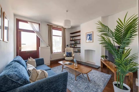 "Relax in style in this cozy, sunlit living room—complete with plush seating, modern decor, and all the comforts of home."