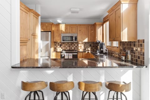 - Fully equipped kitchen with stainless steel appliances and wood cabinets   - Granite countertops and breakfast bar perfect for casual dining   - Ideal setup for cooking and entertaining in your mountain getaway