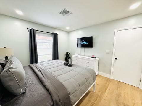 Enter our cozy bedroom setup, featuring a roomy king-size bed and a practical smart TV for your entertainment needs. The simplicity of the space ensures a comfortable atmosphere, making it a laid-back retreat after a long day.