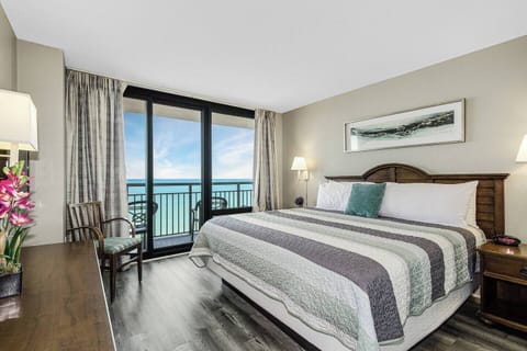 Welcome the day with a sunrise awakening in our bedroom, where a bed near the balcony offers a front-row seat to the morning sun painting the sky over the ocean.