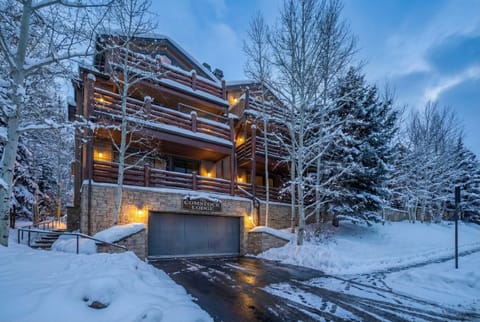Exterior: View of the front of the condo building and forested surroundings