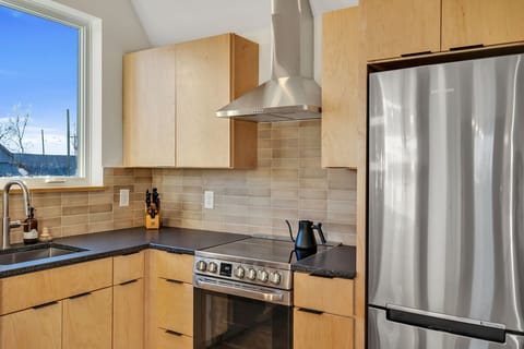 High-end appliances, coffee bar, dishwasher and electric range.