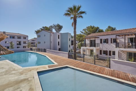 This inviting pool area offers a serene escape for guests. Enjoy the sunny weather and the calm ambiance.