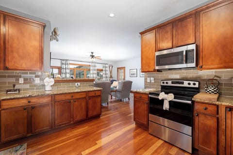 Your spacious kitchen features warm wood cabinets, granite counters, and stainless appliances—perfect for preparing meals while enjoying mountain views.