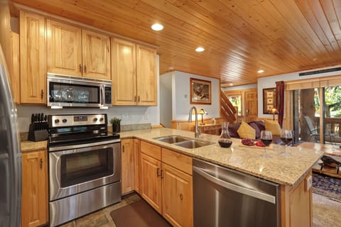Timber Wolf Lodge 10 D has a stainless steel range with microwave above, and stainless steel dishwasher and sink