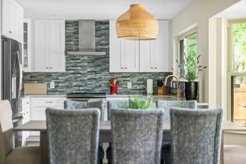 Our dining table has 8 chairs near the fully stocked kitchen for easier serving.