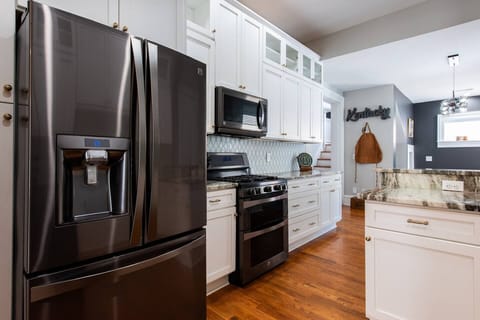 Large kitchen with high end appliances, gas stove and counter space for preparing meals
