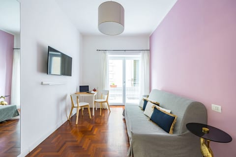 Quadruple Room, Balcony | Living area | TV