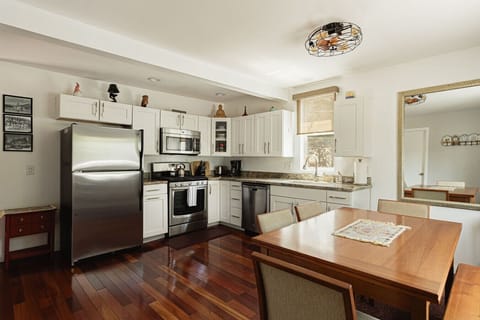 Open concept kitchen and dining space with seating for up to six at the dining room table.